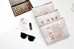 Detailed flat lay of three cream cotton canvas toiletry bags with black zipper closures