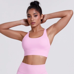 Detailed close-up of pink criss-cross back sports bra and high waist yoga leggings