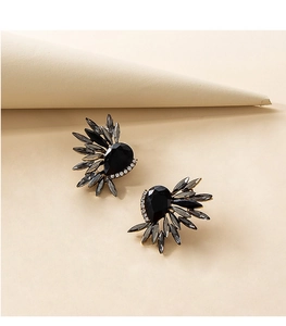 Detail of wing-shaped earrings with black pear gem and grey marquise crystals