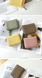 Detailed view of genuine leather accordion card holders in yellow, green, pink and taupe