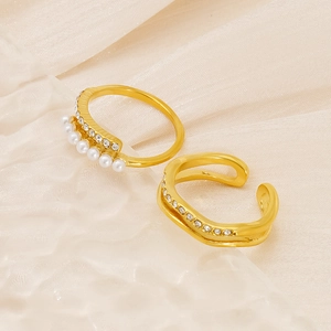 Detail of 18K gold ring set with micro-inlaid pearls and wave design on velvet