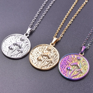 Detail of mushroom relief pendants in silver, gold, and iridescent finishes on dark background