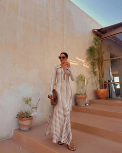 Detail of the plunging V-neckline and geometric chain print on this boho maxi dress