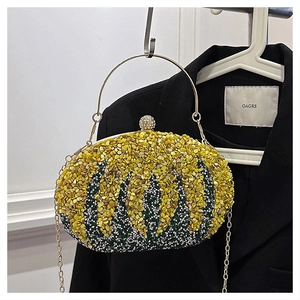 Detail of pumpkin-shaped evening bag with floral beads, gold handle, and crystal clasp