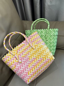 Detail of handmade woven tote bags with diamond patterns in pink and green colorways