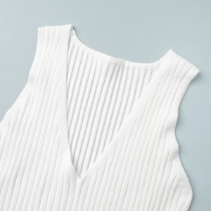 Close-up of white rib-knit fabric texture and deep V-neckline of the summer dress