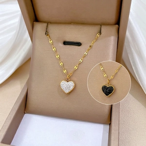 Minimalist gold titanium heart pendant necklace with shimmering white and black stones