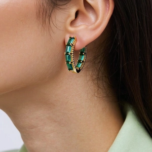 Close-up of 18K gold plated hoop earrings featuring emerald cut green zircon stones
