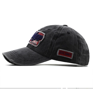 Detail of vintage washed black denim baseball cap with 3D embroidery and distressed edges