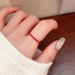 Detailed macro view of a minimalist red enamel snake ring with twisted rope texture