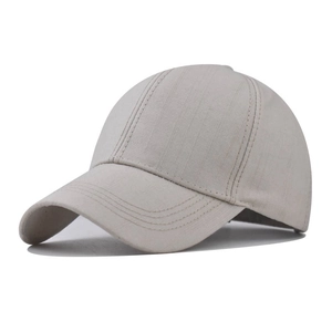 Close-up of light gray cotton baseball cap crown with textured twill fabric and reinforced stitching