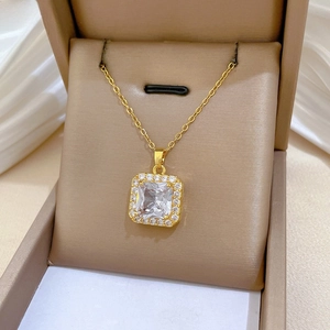 Macro shot of square zircon pendant in a premium gift box with gold-plated finish