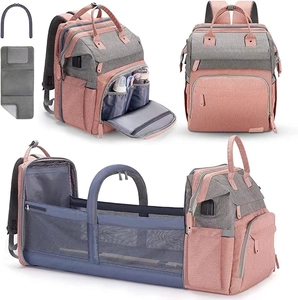 Multipurpose pink diaper bag backpack with built-in foldable crib and insulated pockets for travel