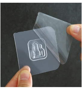 Close-up of transparent self-adhesive power strip holder patch with peel-off backing