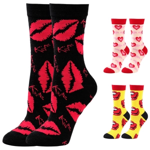 Detail of three pairs of cotton socks with heart, kiss, and lip patterns in studio lighting