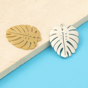 Detailed view of mirror-polished gold and silver leaf pendants for DIY jewelry making