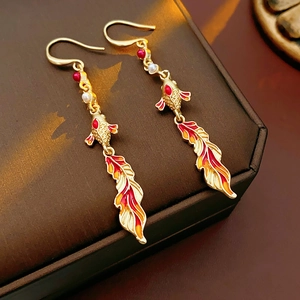 Detailed macro view of vintage koi fish earrings with enamel finish and white pearls