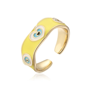Close-up of 18K gold plated ring with yellow enamel heart and evil eye detail