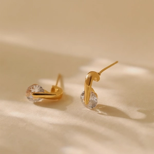 Fashionable 18K gold plated curved stud earrings with round cubic zirconia stones