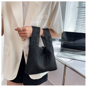 Detail of a chic black rhinestone handbag with sparkling crystals for elegant evening events