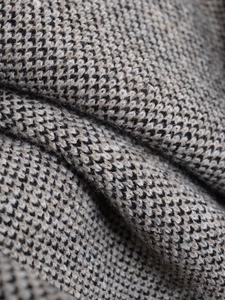 Macro shot of high-density tricolor jacquard knit fabric with micro-check pattern detail