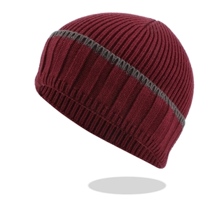 Detail of burgundy ribbed knit beanie showing thick texture and dark grey stripe pattern