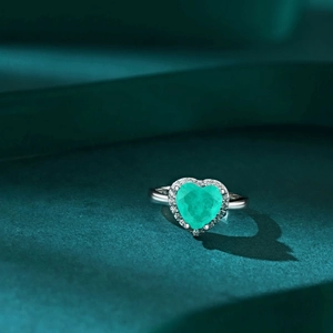 Macro shot of S925 sterling silver stamp on heart-shaped emerald green zircon ring