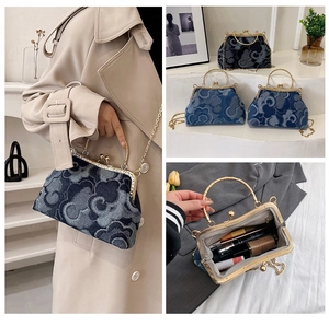 Detail view of denim kiss-lock bags with cloud patterns, chain straps and interior layout
