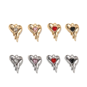 Flat lay of melting heart glass rhinestone pendants in gold and silver alloy finishes