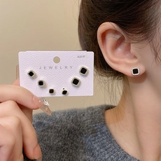 Macro shot of S925 sterling silver black square zircon stud earrings set on a card