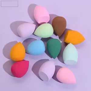Colorful makeup sponge set with waterdrop and flat-cut shapes on purple background