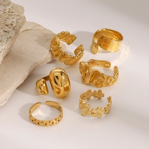Macro detail of six-piece golden vintage ring set on natural stone display