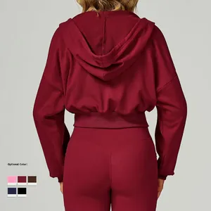 Burgundy cropped zip hoodie and leggings set for women's fitness, back view in studio light