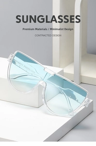 Detail view of transparent blue oversized sunglasses on a minimalist white platform