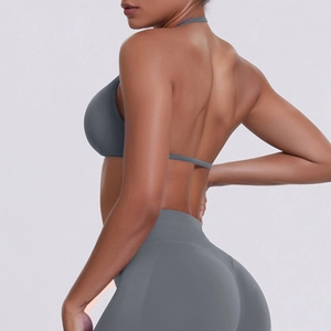 Rear view of grey seamless backless yoga set featuring halter sports bra and high-waist leggings