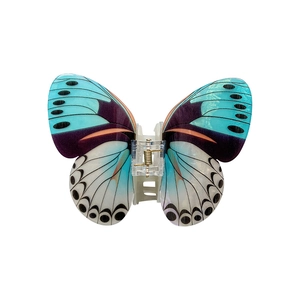 Elegant blue butterfly hair claw clip with silk-like finish and golden metal spring