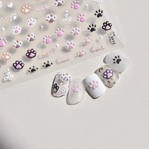 3D embossed nail stickers featuring cute cat paw designs in pink and black patterns