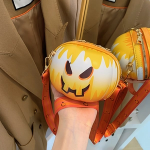 Detail of pumpkin crossbody bag with flame patterns and black jack-o-lantern face