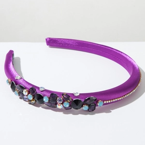 Detail of purple satin headband with handcrafted colorful rhinestones and gold trim