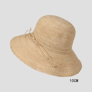 Detail of 10cm wide brim on handmade raffia straw hat with delicate bow decoration
