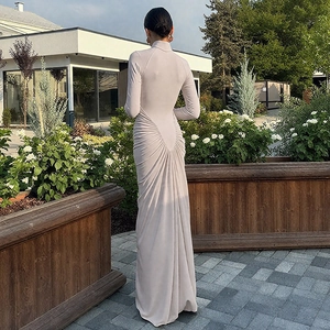 Detail view of ruching design on back of light grey long-sleeve slim fit maxi dress