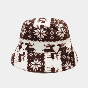 Detail of warm winter bucket hat featuring Nordic reindeer and snowflake plush patterns