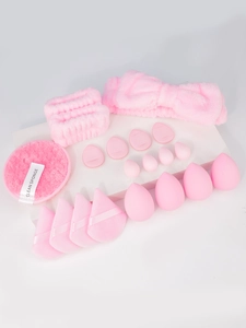Detailed view of a 20-piece pink makeup set with beauty sponges and headband