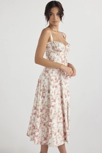 Detail of floral spaghetti strap dress showing bustier design and side slit hem