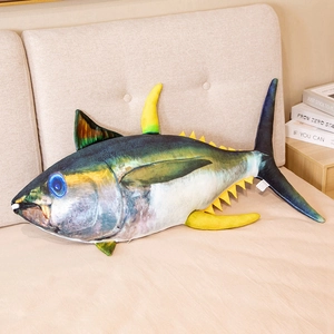 Detail of cartoon tuna plush pillow showing realistic print and soft fabric in home setting