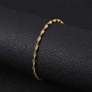 Macro shot of minimalist 18K gold plated stainless steel twisted water wave chain jewelry