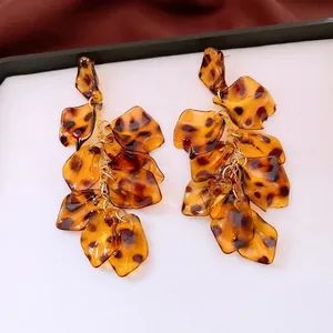 Retro acrylic leopard print petal tassel earrings with gold link chain on white background