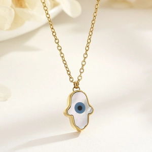 Detailed close-up of 18k gold plated Hamsa necklace with shell inlay and Evil Eye symbol