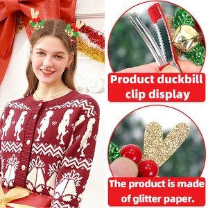 Detail view of glitter reindeer antler hair clips with bells and festive decorations