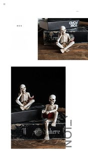 Macro shot of two vintage resin skeleton figurines reading red books on a wooden desk